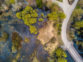 A small bridge over beautiful river in a field near the forest. Summer landscape. top view