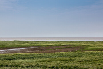 Flat salt marshes and the North Sea of North Germany