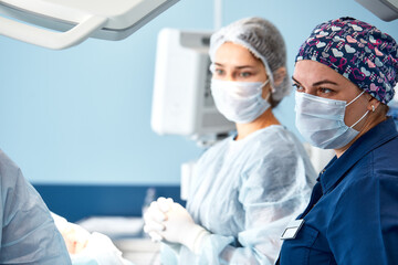 Concentrated Surgical team operating a patient in an operation theater