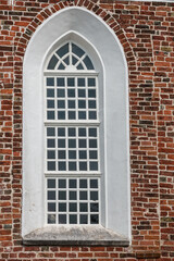 Window of a church with walls of bricks