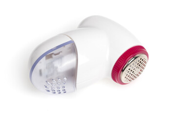 Lint remover on a white background. Electric lint remover close-up on a white background.