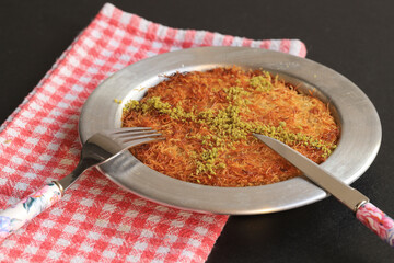 Turkish dessert kunefe, kunafa, kadayif with pistachio powder and cheese, served hot, very sweet....