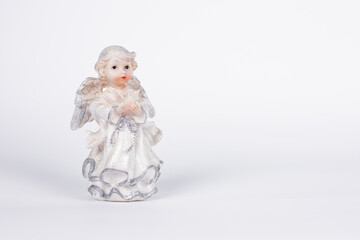 statuettes of angels on a white background