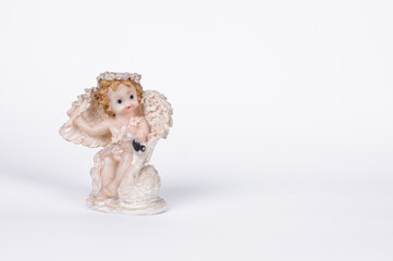 statuettes of angels on a white background