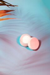 cosmetic bottles in neon light. Stylish neon background 