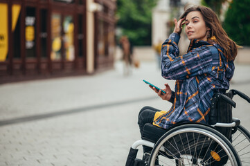 Woman with disability using a smartphone while out in the city