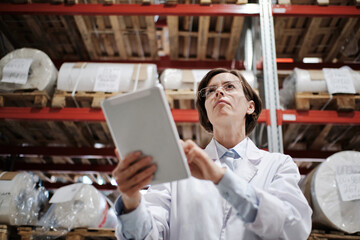 Female worker using tablet at the factory
