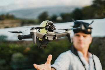 Man in VR goggles controlling drone