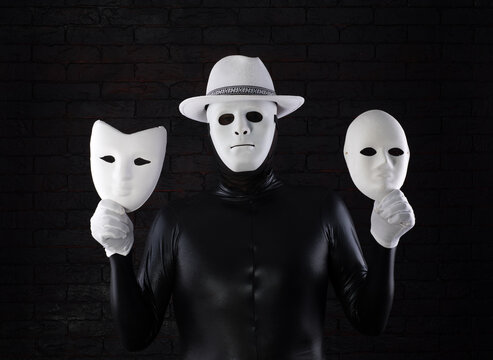 two-faced man in a white mask on a black background