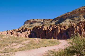 Winding dirt road to ancient ruins of cavetown near Goreme in Cappadocia. Popular travel destination in Turkey. UNESCO World Heritage Site