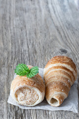 Puff pastry horns isolated on rustic wooden table