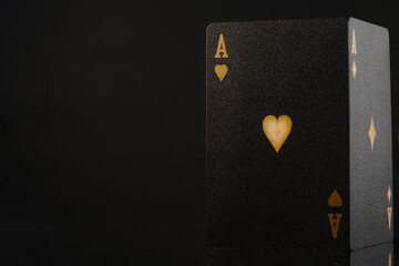 Casino, online casino. Black poker card, ace of hearts with gold embossing on a black background. 3D image. Minimalism. Gambling, poker, game strategy. Advertising, banner, poster. - 469777427