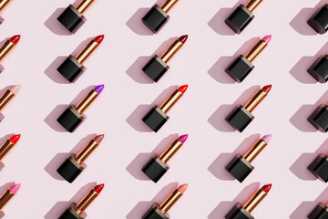 Obraz premium Multi-color lipsticks, lip gloss on trendy pastel pink background. Cosmetic products. Makeup accessories. Skin care. Beauty pattern 3d.