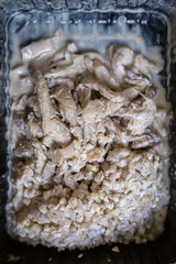 buckwheat porridge with meat close-up in a black disposable container