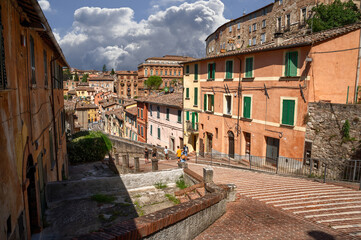 Perugia, Umbria, Italy. August 2021. Amazing view in the historic center: the ancient aqueduct is a magnificent promenade overlooked by the colorful houses. Beautiful summer day.