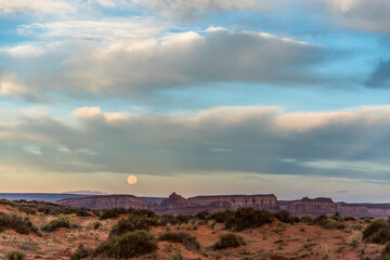 Fototapeta na wymiar Full moon in the morning over Monument Valley
