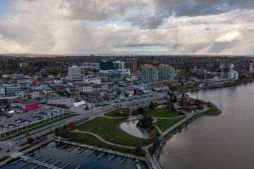 sunset fall Drone view of Barrie waterfront downtown with blue skies and clouds  centennial park and lakeshore drive  road with fall colours   - obrazy, fototapety, plakaty