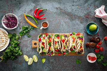 Chicken tacos with grilled meat, avocado, fresh vegetable salad and sauce salsa