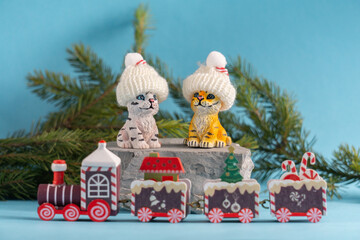 Figures of tigers in caps on a blue background