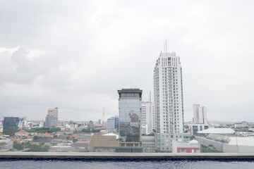 Indonesia skyline over Surabaya City. View of the cityscape sky scrappers building from rooftop.