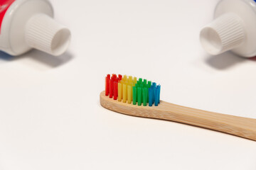 Toothpaste (tube) and wooden toothbrush.