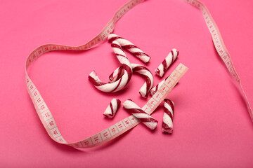 Broken candy cane and space for text on color background, top view