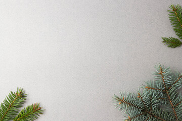 Fir twigs on a gray background, the basis for a Christmas and New Year greeting card 2022