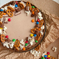Chocolate cake decorated with colorful dragees and cookies