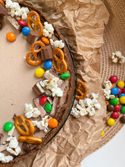 Chocolate cake decorated with colorful dragees and cookies