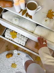 Modern open chest of drawers with woman clothes and accessories