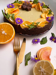 Chocolate cake decorated with lemon and orange slices for romantic tea party