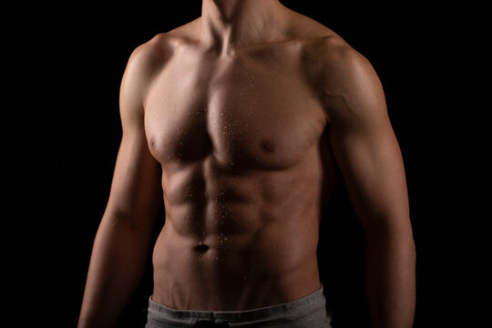 Man Showing ABS. Muscle man Posing. Strong Body Concept. Topless Sportman Bodybuilder. Six Pack