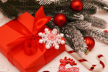   Christmas or New Year Decoration, background. Ornament with gift boxes, red Christmas baubles, fir branches on an old white wooden table with copy space.