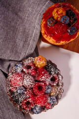 Fresh cake with raspberries in powdered sugar. Dessert in a cafe for breakfast.