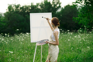 woman artist outdoors easel drawing creative landscape