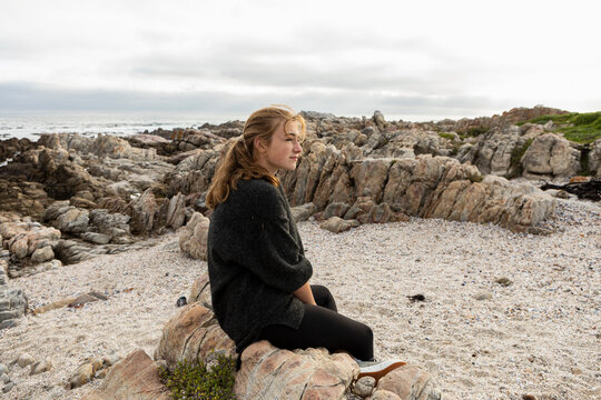 Teenage girl exploring the rocky coastline of the Atlantic Ocean.  