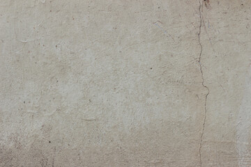 Beige concrete wall texture with interested crack in corner 