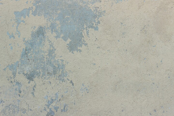 Old beige concrete wall with different spots and divorces	
