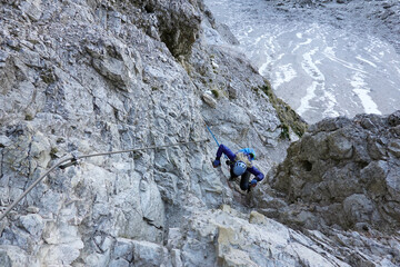 Woman on via ferrata of Monte Paterno. Adventure activity in Dolomites, Italy 