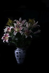 Pink flowers in a white and black vase