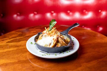 artisan potato chips with grilled cheese in a pan with red background