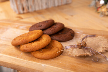 Home made giant cookies on wooden table with pieces of star anise and cinnamon