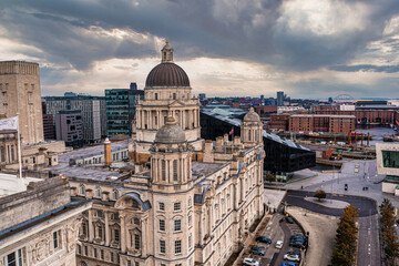 Fototapeta premium Aerial close up of the tower of the Royal Liver Building in Liverpool, UK during beautiful sunset.