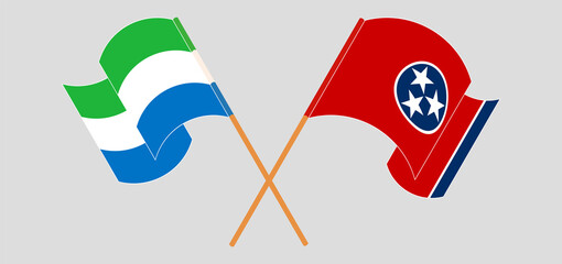 Crossed and waving flags of Sierra Leone and The State of Tennessee