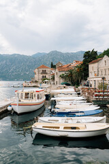 Fototapeta na wymiar Boat dock with fences off the coast of Perast. Montenegro