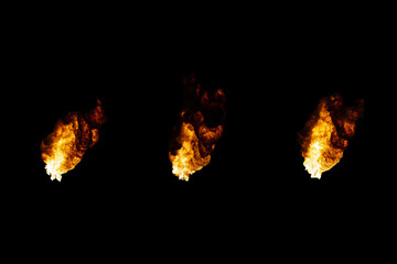 Three flames of oil torches isolated on a black background.