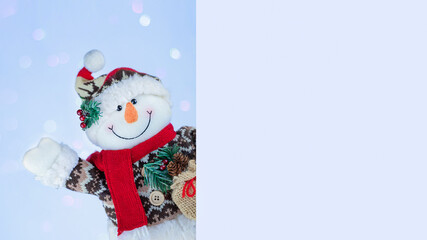 Happy snowman behind blank card stock photo banner with copy space