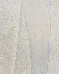 Obraz premium White sand texture with lines and grain
