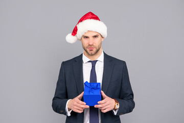 businessperson guy wear santa hat holding purchase box on grey background, purchase