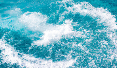 Splashes of blue, sea water with foam bubbles. A splash of nature on a summer day. blue sea background with splashing water. sea vacation concept.